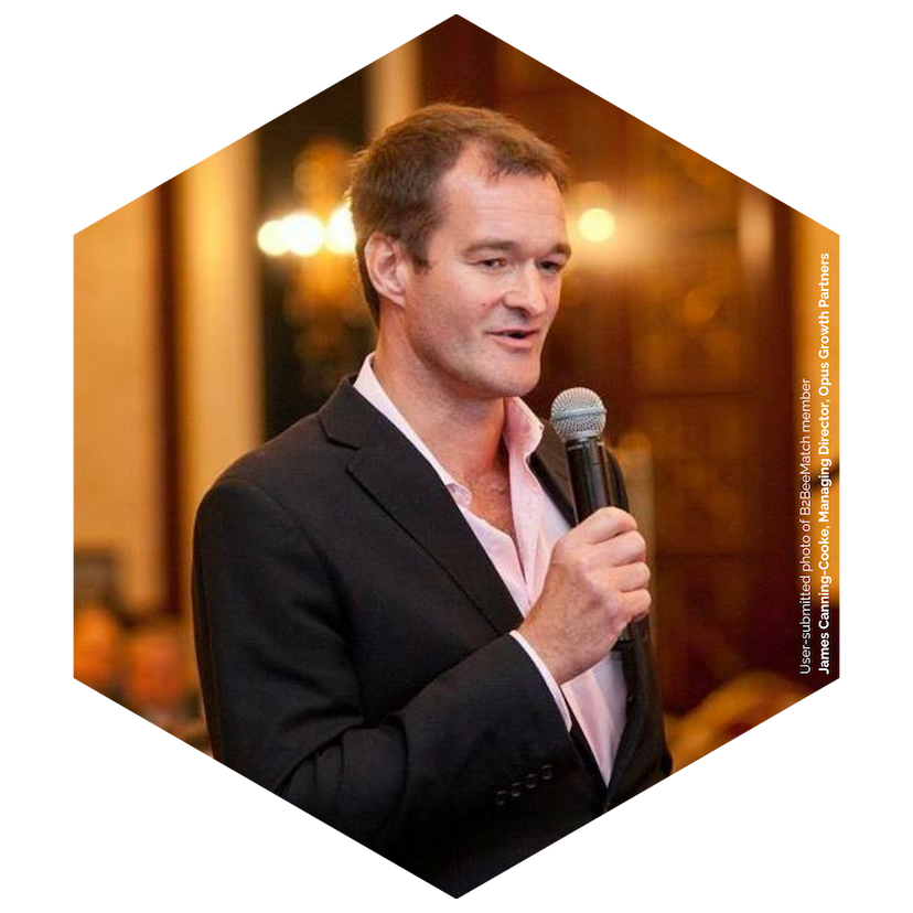 James Canning-Cooke, B2BeeMatch member, holds a microphone and addresses a business event.